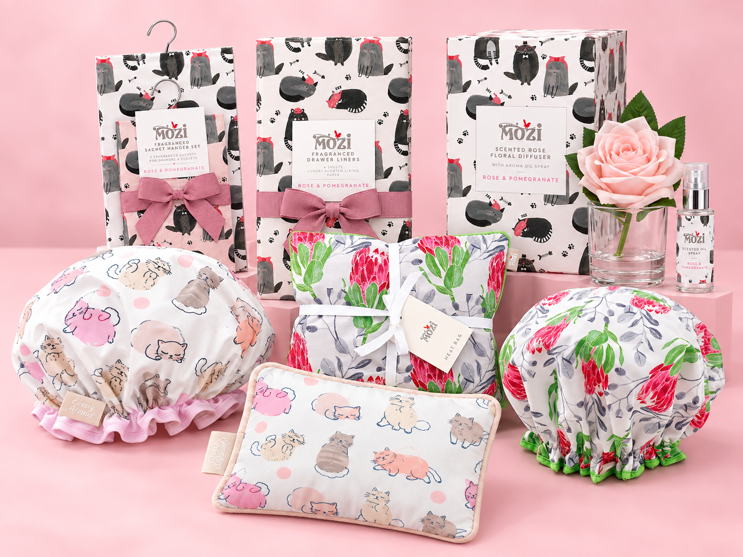 Mozi floral gifting and home fragrance products arranged on a pink background